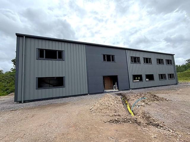 Completed industrial unit with anthracite and dark grey wall cladding and a flat panel centre section