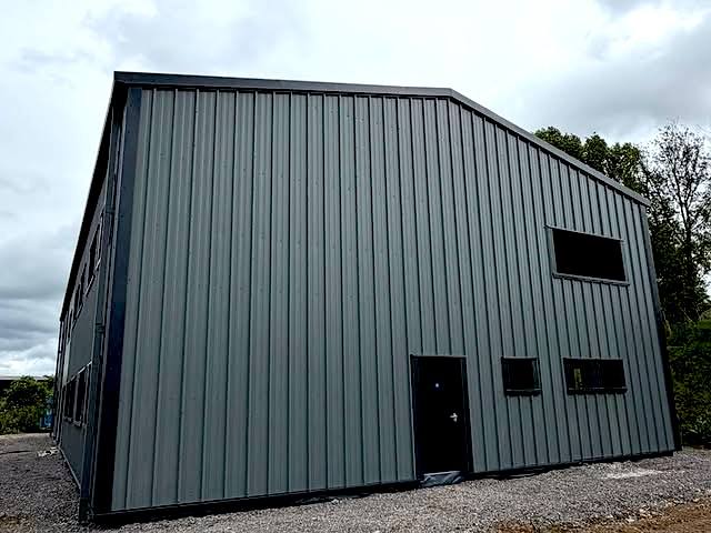 Gable end of an industrial unit with profiled cladding and a steel personnel door