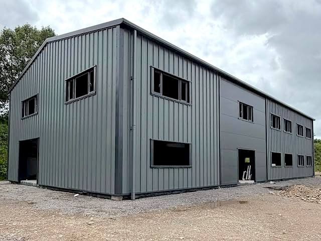 Industrial unit with vertical profiled wall cladding and powder coated window flashings
